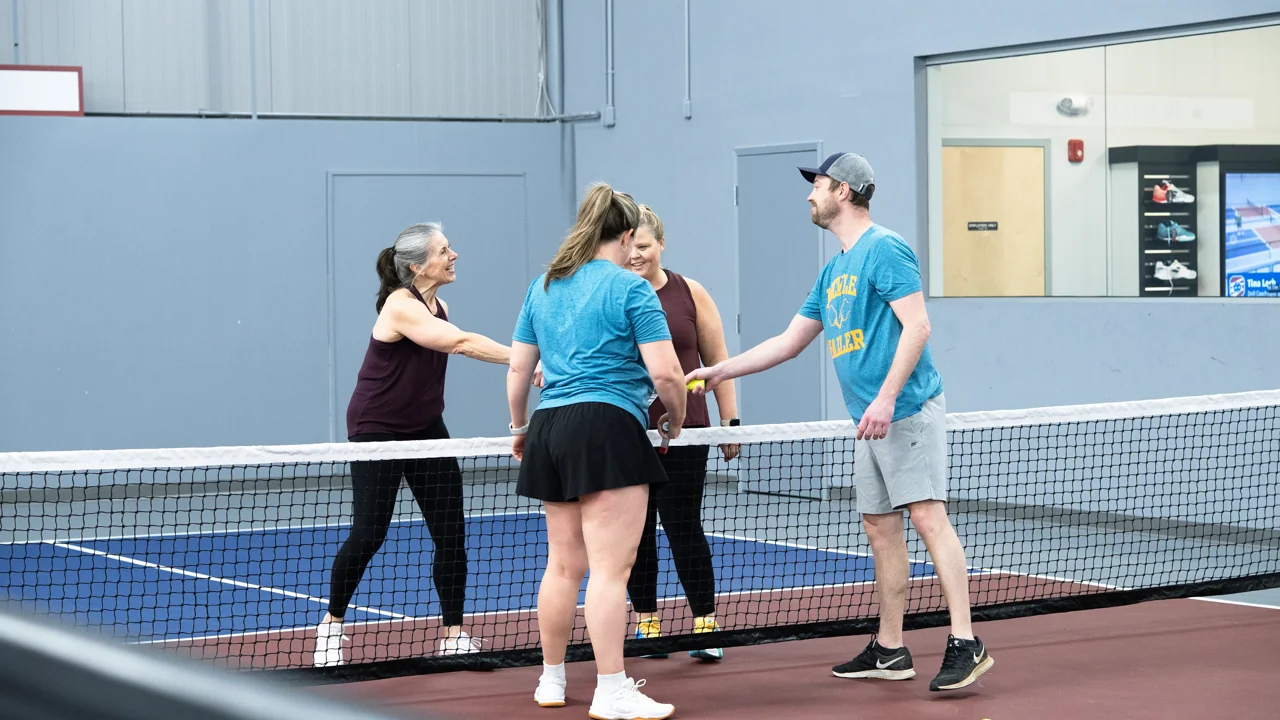 Players greeting one another across the pickleball net